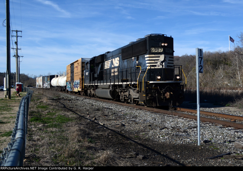 NS yard job E23 at MP 172 on the "Old Main Line" heads south en route to Montview Yard with four cars received from CSX.  The McBride Sign Company's flag waves on the Amherst County side of the James River.